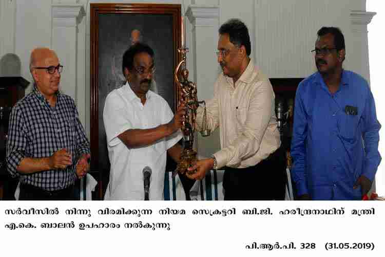 Minister AK Balan presenting memento to the retiring Law Secretary